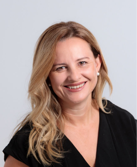 Professional headshot of a lady on a white background.