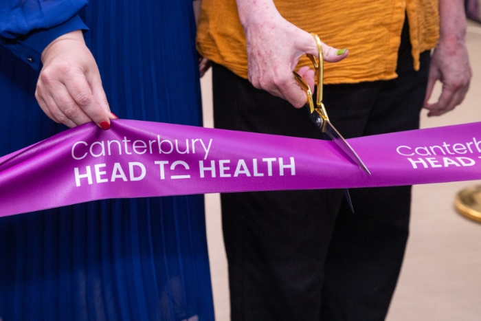 Grand opening event photography of two people cutting a ribbon.