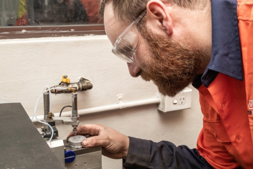 Marketing photo taken by a sydney industrial photographer. The man is analysing a sample.