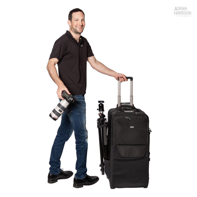 Sydney corporate photographer Adrian with camera and photography bag and tripod.
