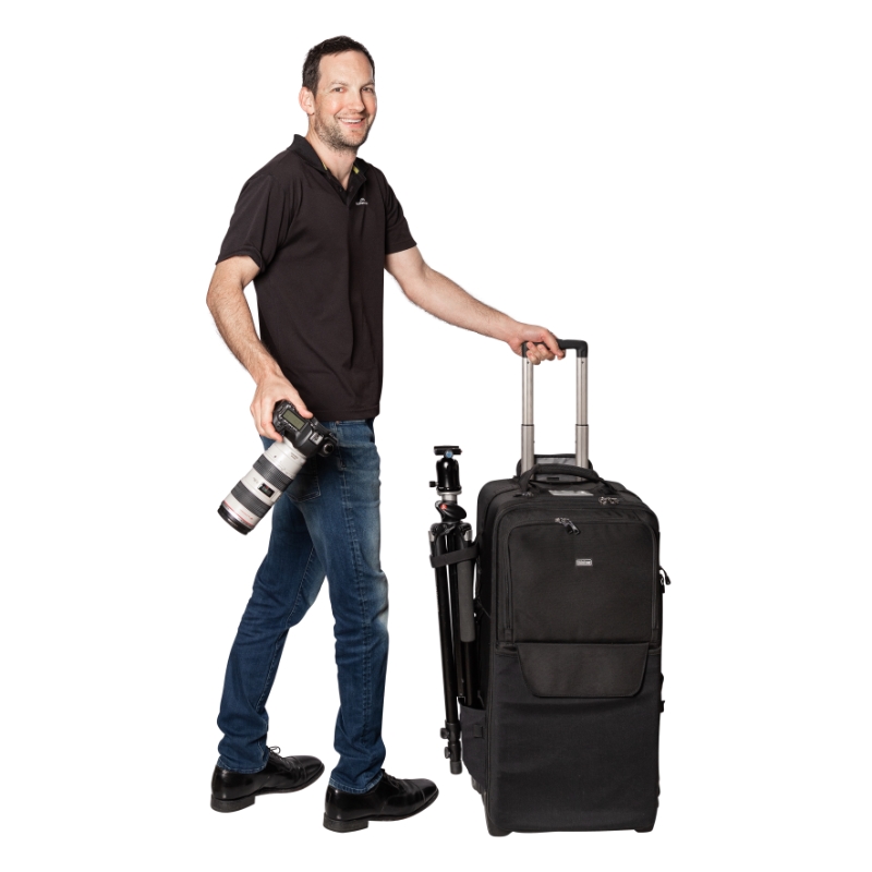 Portrait of industrial photographer Adrian with camera and camera bag ready to shoot.